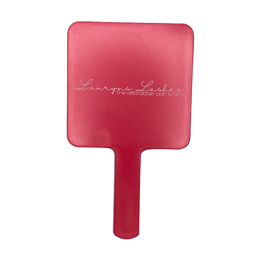 pink handheld mirror with logo on the back